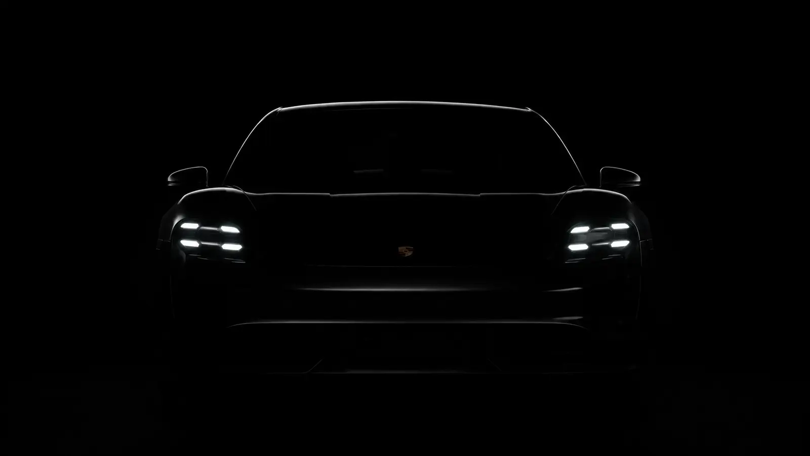 АВТО 1000911 чёрный Porsche Taycan в темноте с фарами