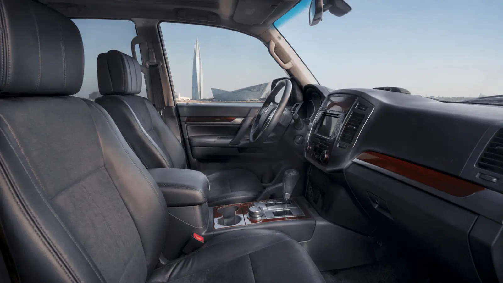 АВТО 1003013 серебристый Mitsubishi Pajero передние кресла и центральная консоль крупным планом у Лахта Центра